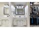 Bright bathroom with double vanity, black hardware, large mirror, and walk-in closet at 5958 Cape Cod Ct, Indianapolis, IN 46250