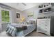 Cozy bedroom featuring a comfortable bed, soft decor, and a white dresser at 5958 Cape Cod Ct, Indianapolis, IN 46250