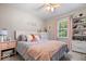 Bright bedroom with plush grey carpet, large window, and cute decorations at 5958 Cape Cod Ct, Indianapolis, IN 46250