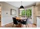 Dining area with a modern chandelier, a round wood table, and sliding doors to a backyard deck at 5958 Cape Cod Ct, Indianapolis, IN 46250