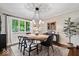 Sunlit dining room featuring an oval table with seating and stylish pendant lighting at 5958 Cape Cod Ct, Indianapolis, IN 46250