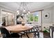 Well-lit dining area featuring a wooden table, modern light fixture, and comfortable seating at 5958 Cape Cod Ct, Indianapolis, IN 46250