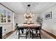 Elegant dining room with natural light, modern light fixture, and seating for six at 5958 Cape Cod Ct, Indianapolis, IN 46250