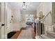 Inviting entryway boasts brick flooring, fresh paint, and access to the dining room and staircase at 5958 Cape Cod Ct, Indianapolis, IN 46250