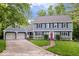 Inviting two-story home with attached garage, well-maintained lawn, and a classic red front door at 5958 Cape Cod Ct, Indianapolis, IN 46250