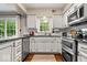 Well-lit kitchen with white cabinetry, stainless steel appliances, and sliding doors to a beautiful view at 5958 Cape Cod Ct, Indianapolis, IN 46250