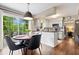 Bright kitchen with a breakfast nook, stainless appliances, hardwood floors, and backyard view at 5958 Cape Cod Ct, Indianapolis, IN 46250