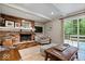 Inviting living room features a brick fireplace, wood floors, and a sliding door to the deck at 5958 Cape Cod Ct, Indianapolis, IN 46250