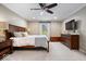 Comfortable main bedroom featuring a ceiling fan, natural light, and carpeted floors at 5958 Cape Cod Ct, Indianapolis, IN 46250