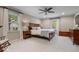 Cozy main bedroom featuring a ceiling fan, two windows, and carpeted floors at 5958 Cape Cod Ct, Indianapolis, IN 46250