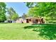 Expansive backyard with a well-manicured lawn and a charming pergola-covered patio at 5979 E Oak Hl Dr, Plainfield, IN 46168