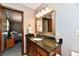 Bathroom with a dark vanity, large mirror, and neutral wall color at 5979 E Oak Hl Dr, Plainfield, IN 46168