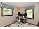 A light-filled bedroom featuring a desk, chair, and dual windows at 5979 E Oak Hl Dr, Plainfield, IN 46168