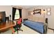 Inviting bedroom with a spacious wooden desk and a cozy daybed featuring stylish decor and calming colors at 5979 E Oak Hl Dr, Plainfield, IN 46168