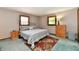 A comfortably furnished bedroom features two windows and a floral rug at 5979 E Oak Hl Dr, Plainfield, IN 46168