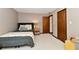 Carpeted bedroom features wood doors, a nightstand, and a gray comforter at 5979 E Oak Hl Dr, Plainfield, IN 46168