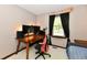 Bedroom showcasing a wooden desk setup, natural light from the window, and calm neutral wall color at 5979 E Oak Hl Dr, Plainfield, IN 46168