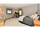 A sunlit bedroom featuring a desk, chair, and windows with floral print curtains at 5979 E Oak Hl Dr, Plainfield, IN 46168