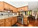 Bright kitchen with stainless steel appliances, granite countertops, and wood cabinets at 5979 E Oak Hl Dr, Plainfield, IN 46168