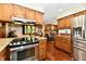 Open kitchen layout with stainless steel appliances and view into the living room at 5979 E Oak Hl Dr, Plainfield, IN 46168