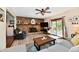 Inviting living room featuring a brick fireplace, wood floors, ceiling fan, and sliding glass doors at 5979 E Oak Hl Dr, Plainfield, IN 46168