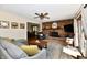 Comfortable living room features a brick fireplace, wood floors, and natural light from sliding glass door at 5979 E Oak Hl Dr, Plainfield, IN 46168
