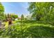 Spacious backyard featuring a playground and well-manicured lawn, perfect for outdoor activities and Gathering enjoyment at 6374 Timberbluff Cir, Avon, IN 46123