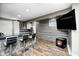 Basement bar with a granite countertop, seating, and modern wall paneling at 6374 Timberbluff Cir, Avon, IN 46123