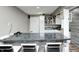 Well-lit basement bar featuring white cabinets, dark countertops, and seating for entertaining at 6374 Timberbluff Cir, Avon, IN 46123