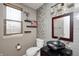 Updated powder room with stylish vanity, decorative mirror, wood blinds and modern fixtures at 6374 Timberbluff Cir, Avon, IN 46123
