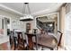 Formal dining room features hardwood floors, large table and an elegant chandelier at 6374 Timberbluff Cir, Avon, IN 46123