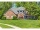 Charming brick home with mature landscaping and a well-maintained lawn, showcasing classic curb appeal at 6374 Timberbluff Cir, Avon, IN 46123