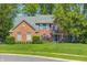 Charming two-story brick home with a landscaped front yard, mature trees, and classic architectural details at 6374 Timberbluff Cir, Avon, IN 46123
