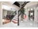 Elegant foyer with marble floors, staircase with dark railings, and views into multiple living spaces at 6374 Timberbluff Cir, Avon, IN 46123