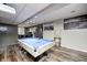 Spacious basement game room with a pool table, bar area, and stylish wood-look flooring at 6374 Timberbluff Cir, Avon, IN 46123