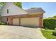 Attached three-car garage offers ample parking and storage space with a brick exterior that matches the house at 6374 Timberbluff Cir, Avon, IN 46123