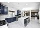 Spacious kitchen with blue cabinets, a large white island with seating and open concept design to other living areas at 6374 Timberbluff Cir, Avon, IN 46123