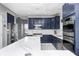 A spacious kitchen with ample counter space, stainless steel appliances and blue cabinets at 6374 Timberbluff Cir, Avon, IN 46123