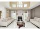 Bright living room featuring marble floors, fireplace, high ceilings, and comfortable seating arrangement at 6374 Timberbluff Cir, Avon, IN 46123