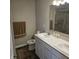 Bathroom featuring double sinks, white cabinets, and a shower with glass doors at 6403 Yuma Ct, Whitestown, IN 46075