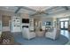 Comfortable common room with elegant seating, built-in bookshelves, and a cozy fireplace for relaxation and gatherings at 6403 Yuma Ct, Whitestown, IN 46075