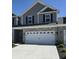 Attractive two-story home with a two-car garage, brick and siding accents, and black shutters at 6403 Yuma Ct, Whitestown, IN 46075