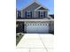 Two-story home featuring a gray exterior, brick accents, and a two-car garage at 6403 Yuma Ct, Whitestown, IN 46075