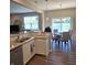 Well-lit kitchen with sleek countertops and a dining area with a view of the pond at 6403 Yuma Ct, Whitestown, IN 46075