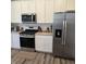 Modern kitchen with stainless steel appliances and white cabinets at 6403 Yuma Ct, Whitestown, IN 46075