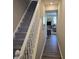 Hallway view into a bright living room with grey furniture and wood flooring at 6403 Yuma Ct, Whitestown, IN 46075