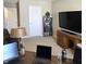 Comfortable living room featuring neutral carpeting, a vintage desk lamp, and a wall-mounted television at 6403 Yuma Ct, Whitestown, IN 46075