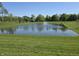 Scenic view of a tranquil pond with a fountain and lush green surroundings at 6403 Yuma Ct, Whitestown, IN 46075