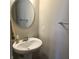 Neat half-bath featuring a pedestal sink with a circular mirror and wall mounted towel bar at 6403 Yuma Ct, Whitestown, IN 46075