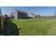 Open backyard with a well-kept lawn, bordered by a wooden fence, and surrounded by neighboring homes at 6491 Enclave Blvd, Greenwood, IN 46143